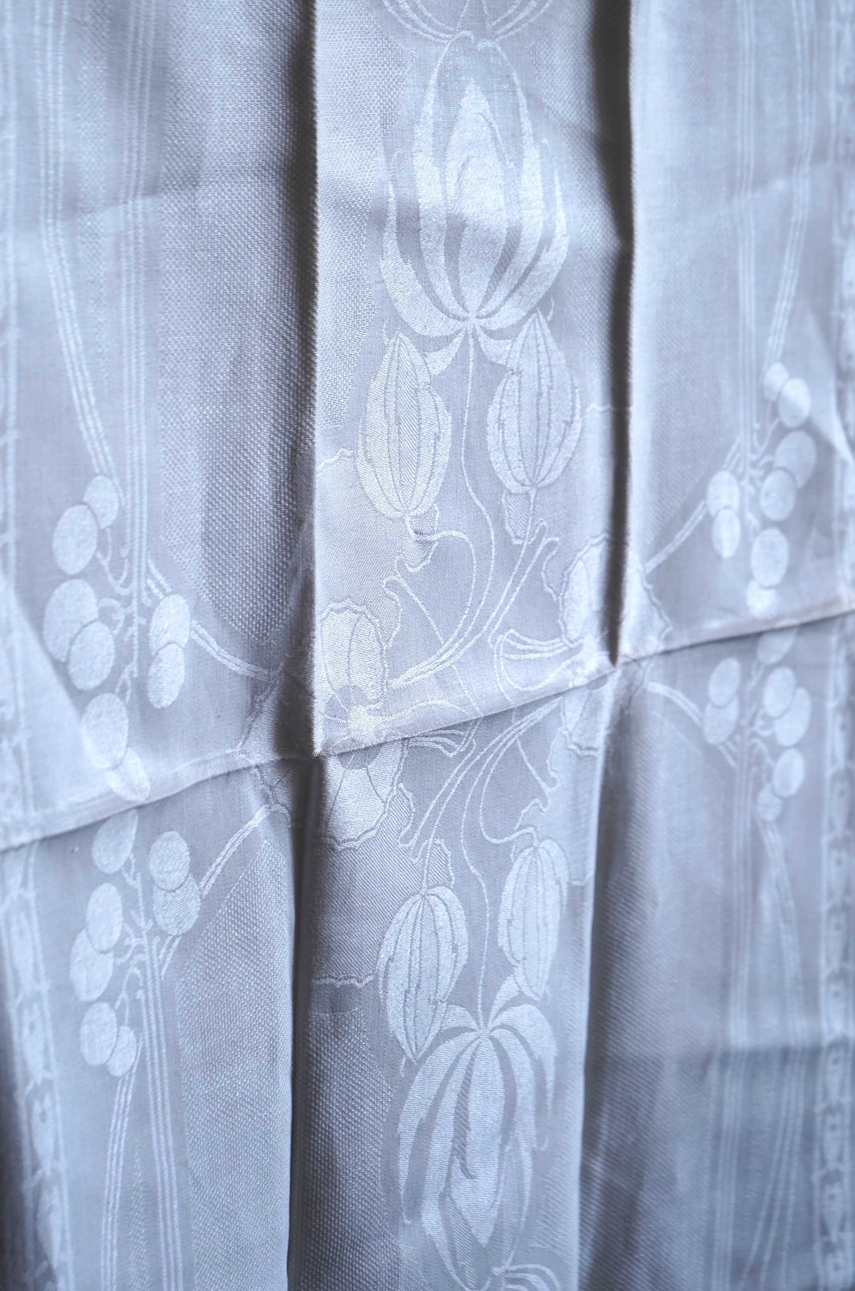 A set of four large Art Nouveau, unused white damask woven hand towels. The pattern having strong Archibald Knox and Walter Crane design elements; with trailing Honesty seeds and Tulip flower heads, these motifs much use